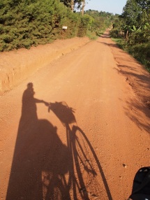 Riding my bicycle home from school on the red roads of Uganda